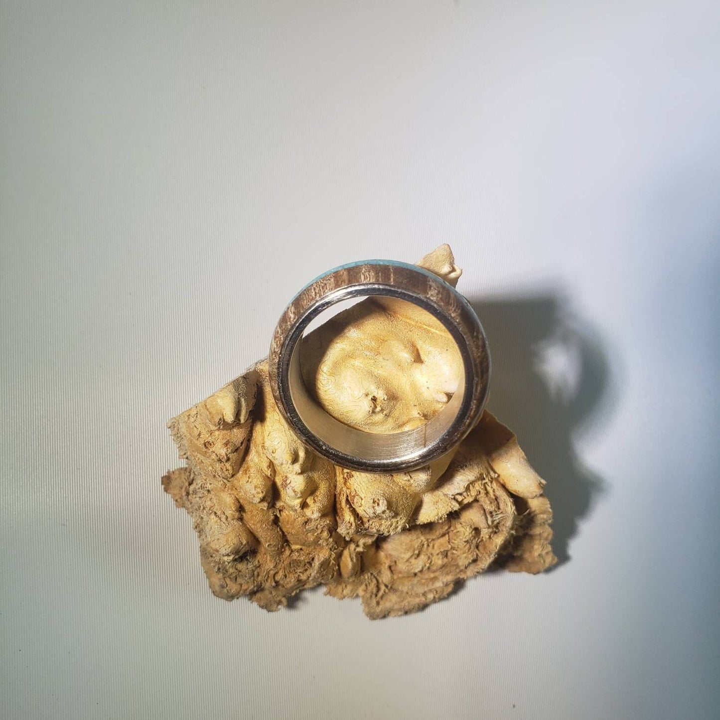 Stabilized maple burl ring with turquoise inlay and steel core.