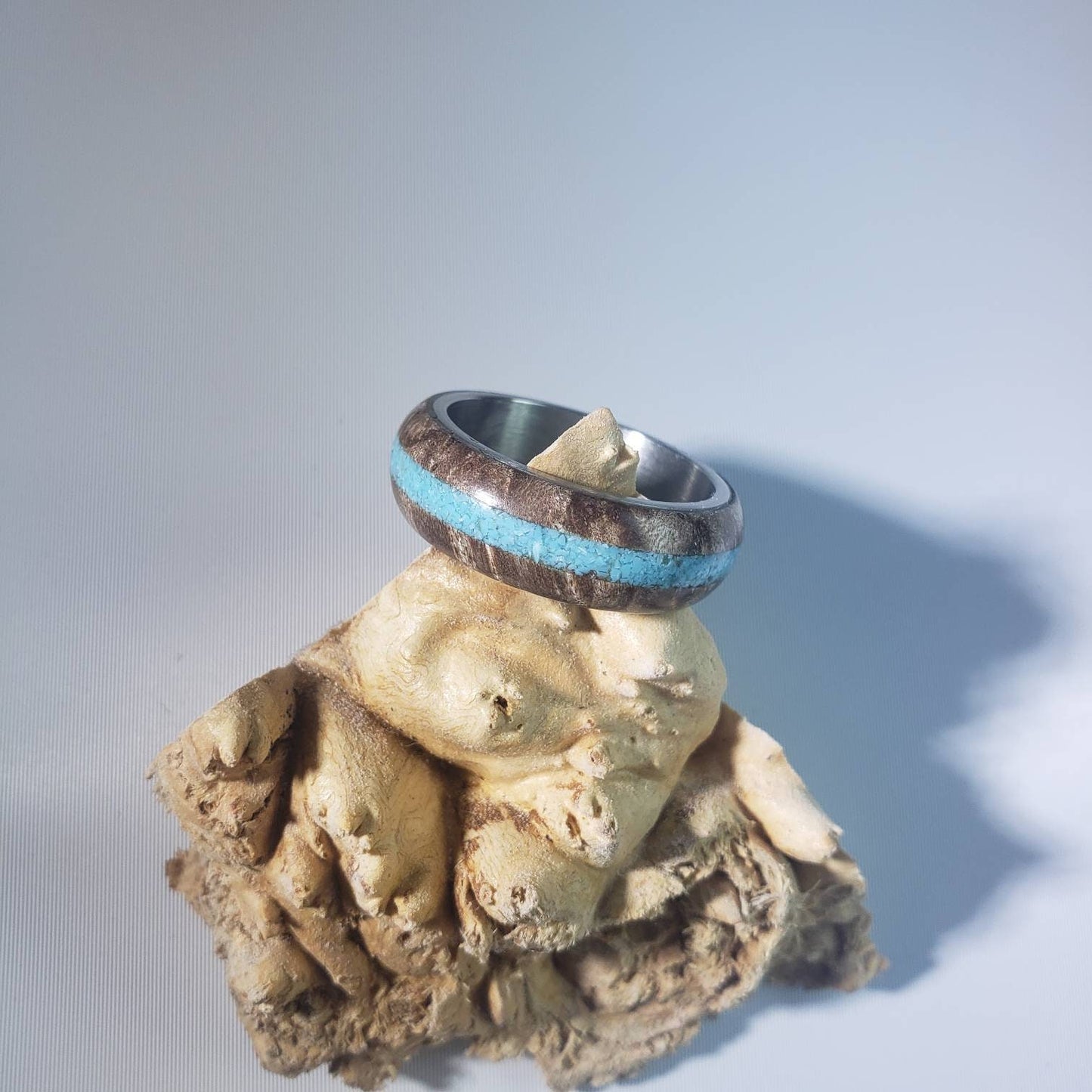 Stabilized maple burl ring with turquoise inlay and steel core.